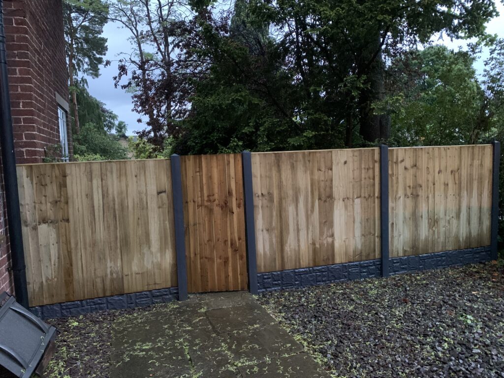 featheredge panel fencing with concrete posts and gravel boards and gate
