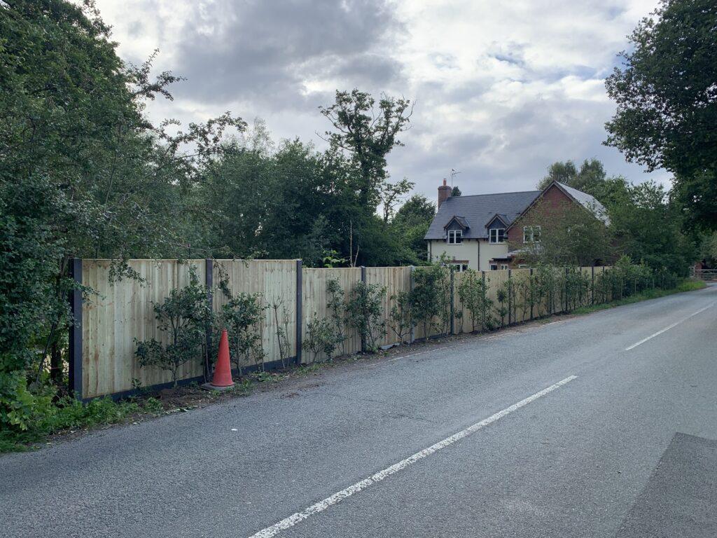 fence with holly hedge